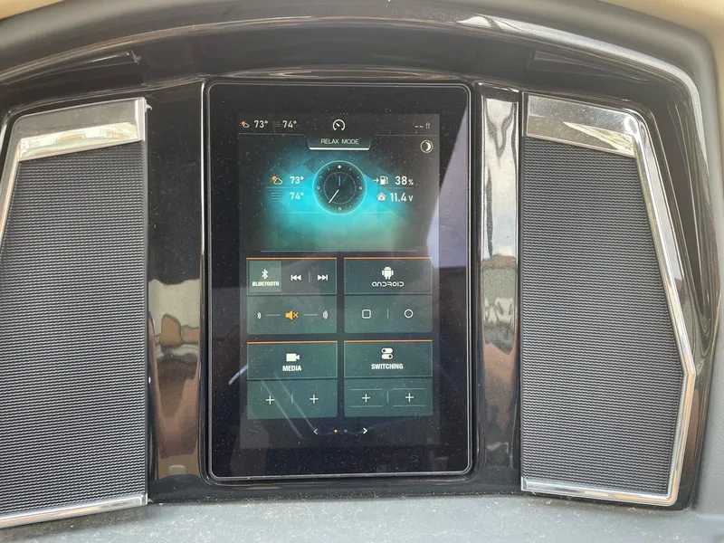 Slide: The Image of 2023 Regency 230 LE3 dashboard touchscreen display showing various controls and settings. - 9