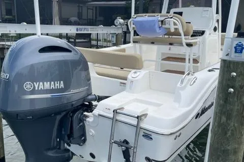 Slide: The Image of 2019 NauticStar 22 XS Offshore boat with Yamaha outboard motor docked. - 2