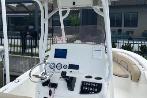 Slide: The Image of 2019 NauticStar 22 XS Offshore boat console with steering wheel and navigation controls. - 5