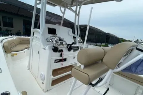Slide: The Image of 2019 NauticStar 22 XS Offshore boat interior with beige seating and control console. - 6