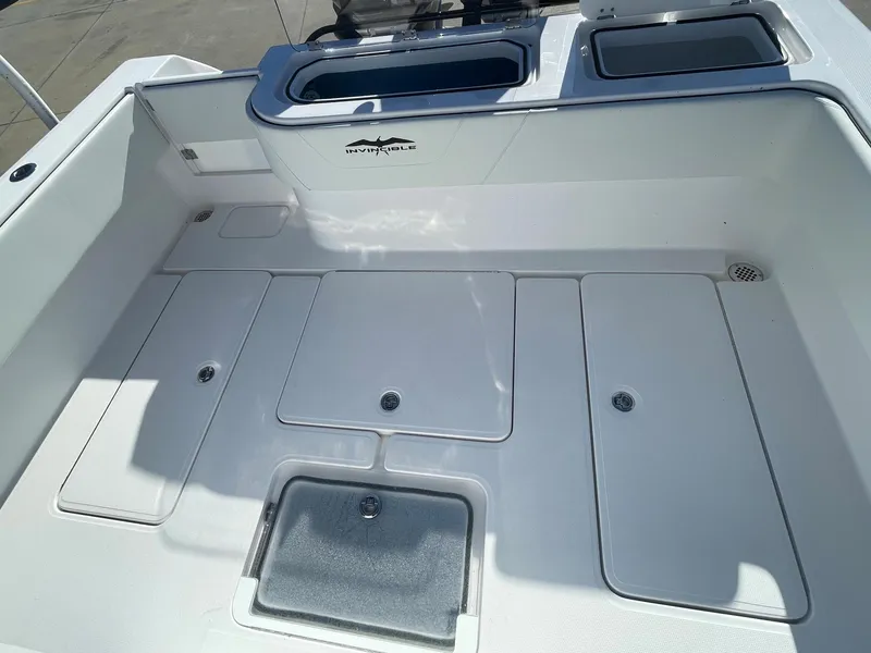 Slide: The Image of 2024 Invincible 33 Open Fisherman boat deck with storage compartments. - 17