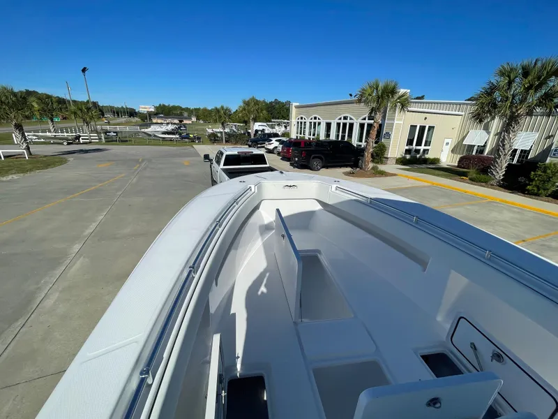 Slide: The Image of 2024 Invincible 33 Open Fisherman boat on a trailer in a parking lot. - 30