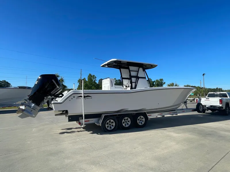 Slide: The Image of 2024 Invincible 33 Open Fisherman boat on a trailer in a parking lot. - 4