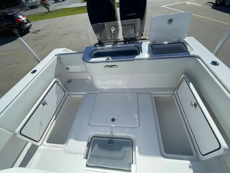 Slide: The Image of 2024 Invincible 33 Open Fisherman boat deck with storage compartments and livewell. - 18