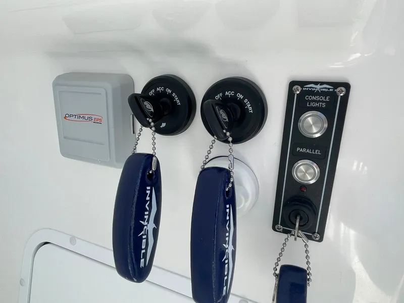 Slide: The Image of Control panel of 2024 Invincible 33 Open Fisherman boat with ignition keys and console lights. - 33