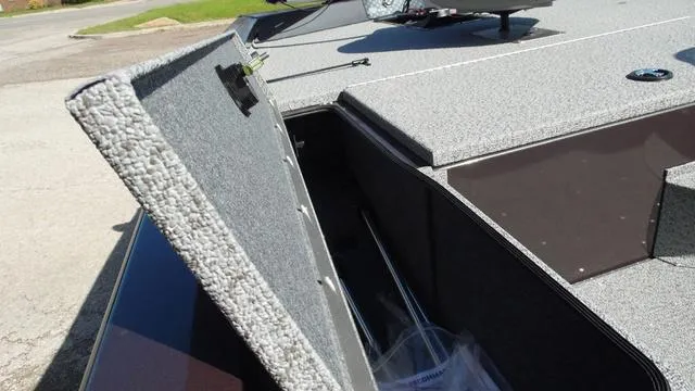 Slide: The Image of 2023 G3 Sportsman 1610 boat storage compartment open, showing interior space. - 11