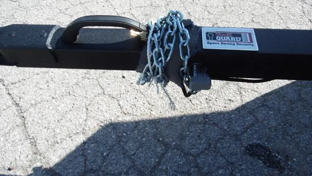 Slide: The Image of Close-up of a 2023 G3 Sportsman 1610 trailer hitch secured with a chain and lock. - 14