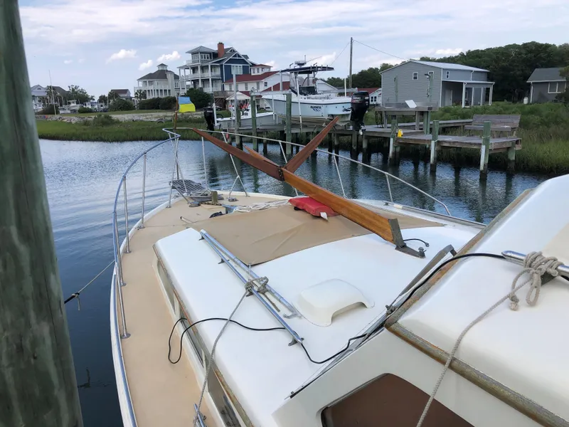 Slide: The Image of 1963 Egg Harbor Convertible Cruiser docked near waterfront homes. - 10