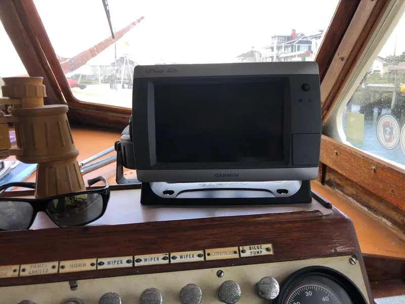 Slide: The Image of 1963 Egg Harbor Convertible Cruiser dashboard with Garmin GPS and vintage controls. - 12