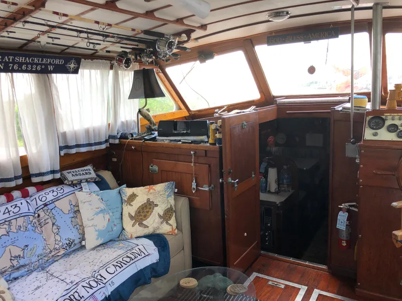 Slide: The Image of 1963 Egg Harbor Convertible Cruiser interior with nautical decor and wooden finishes. - 14