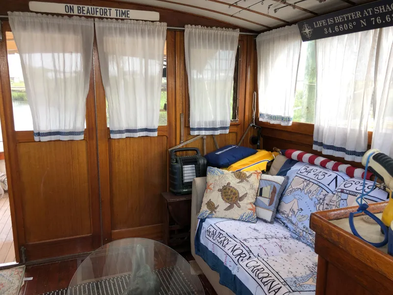 Slide: The Image of 1963 Egg Harbor Convertible Cruiser interior with cozy seating, nautical decor, and wooden accents. - 15