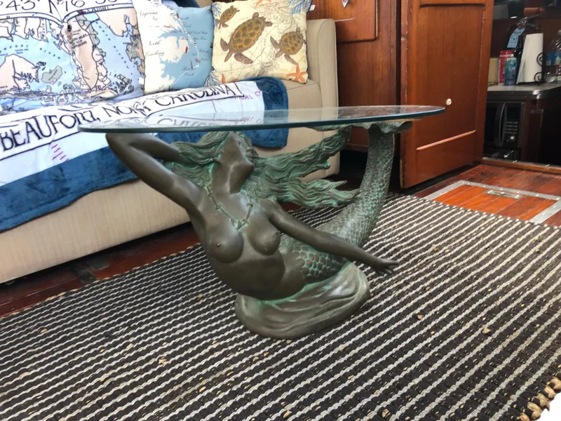 Slide: The Image of Mermaid-themed glass coffee table on striped rug in 1963 Egg Harbor Convertible Cruiser. - 17
