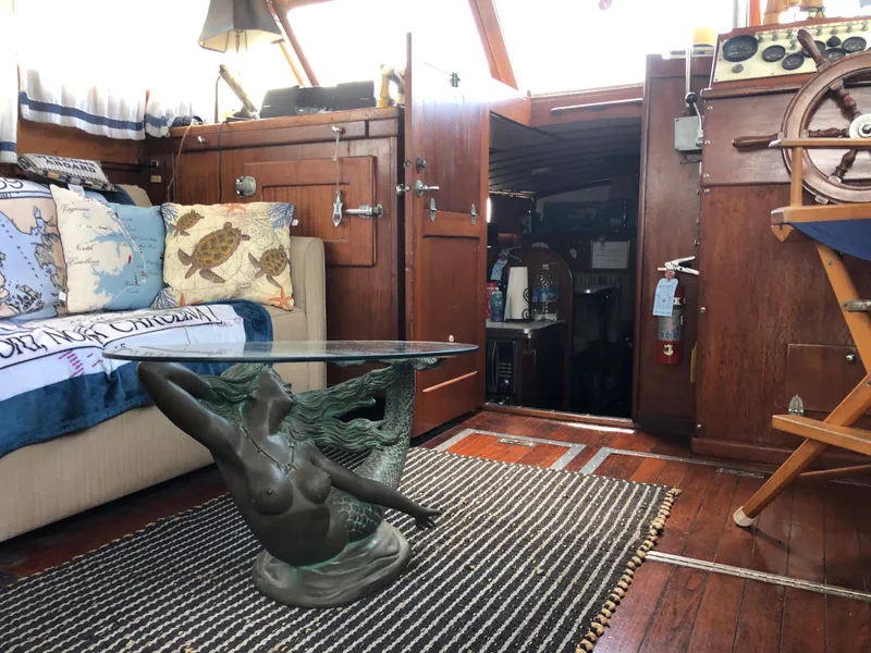 Slide: The Image of Interior of a 1963 Egg Harbor Convertible Cruiser with nautical decor and mermaid table. - 18