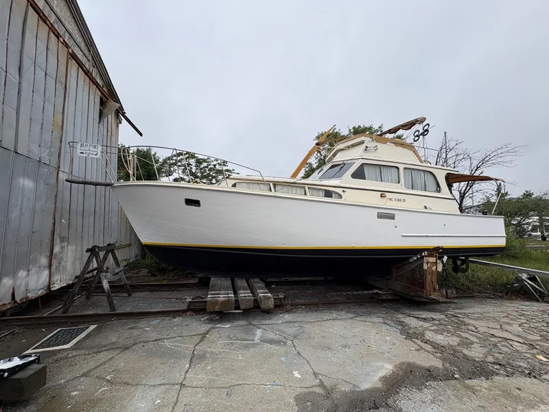 Slide: The Image of 1963 Egg Harbor Convertible Cruiser on dry dock, white hull, classic design. - 2