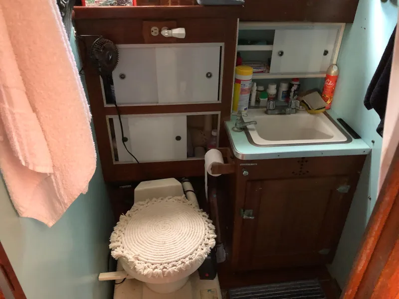 Slide: The Image of 1963 Egg Harbor Convertible Cruiser bathroom with sink, toilet, and storage cabinets. - 23