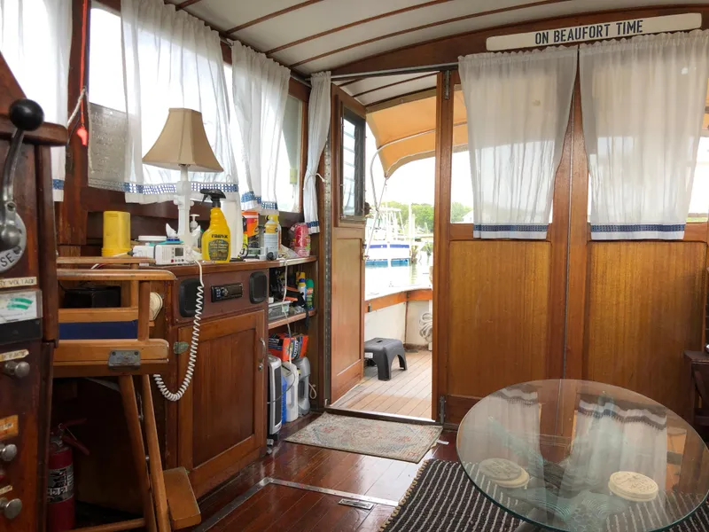 Slide: The Image of Interior of a 1963 Egg Harbor Convertible Cruiser with wooden decor and nautical elements. - 27