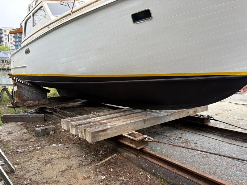 Slide: The Image of 1963 Egg Harbor Convertible Cruiser on dry dock, showcasing hull and classic design. - 5