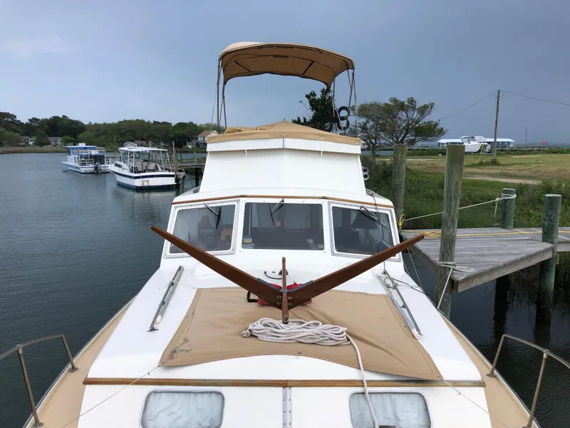 Slide: The Image of 1963 Egg Harbor Convertible Cruiser docked, featuring classic design and tan canvas covers. - 8