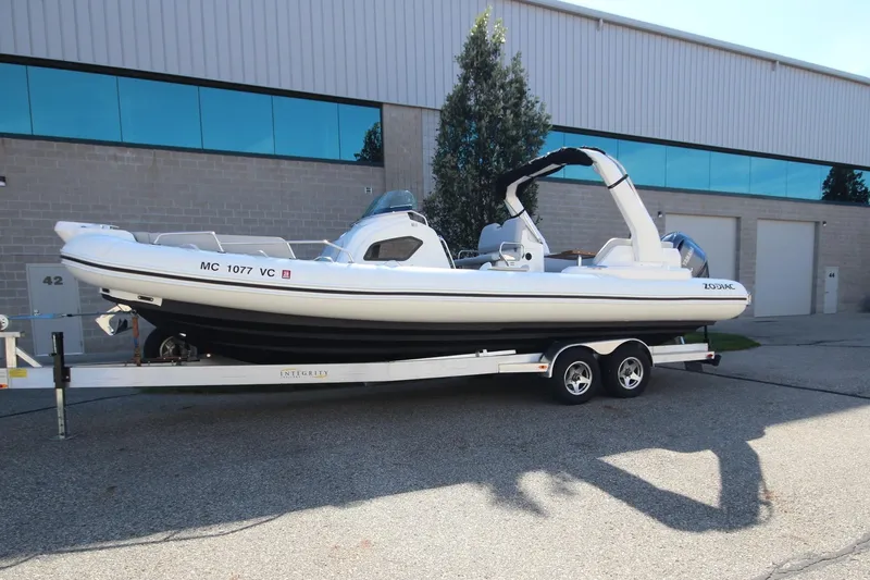 Slide: The Image of 2024 Zodiac MEDLINE 9 NEO boat on trailer, twin 300hp engines, parked outside. - 1