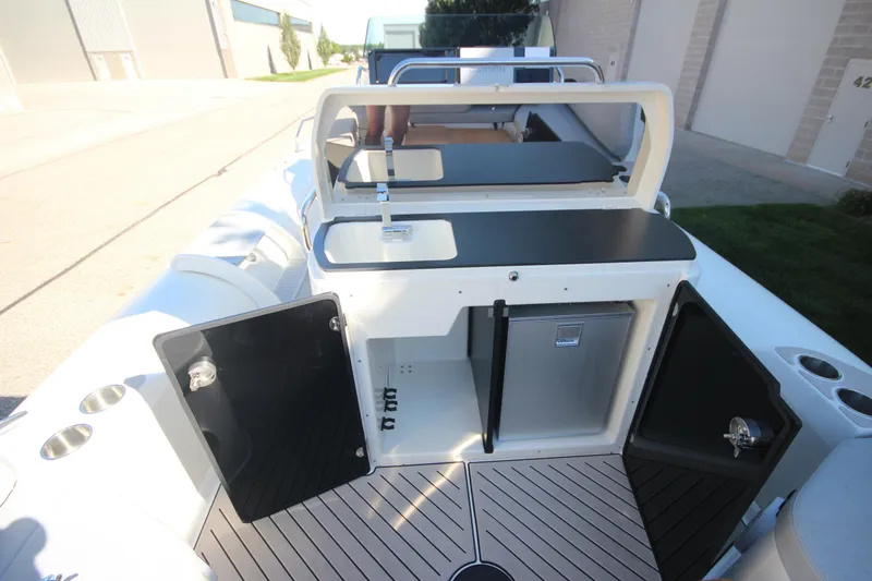 Slide: The Image of 2024 Zodiac MEDLINE 9 NEO boat interior with open storage compartments and sleek design. - 15