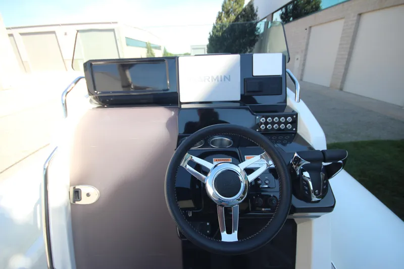Slide: The Image of 2024 Zodiac MEDLINE 9 NEO boat dashboard with Garmin navigation system and steering wheel. - 19