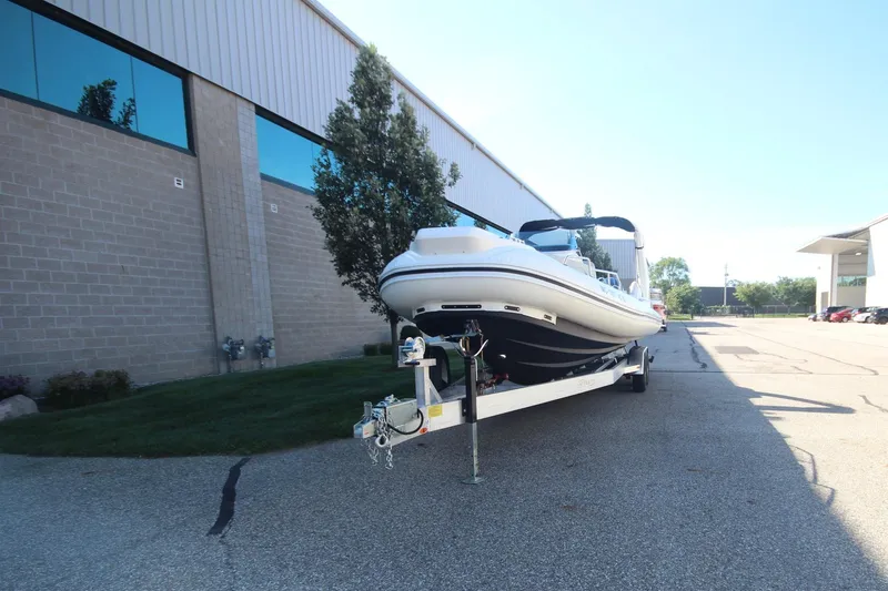 Slide: The Image of 2024 Zodiac MEDLINE 9 NEO boat on trailer outside industrial building. - 2