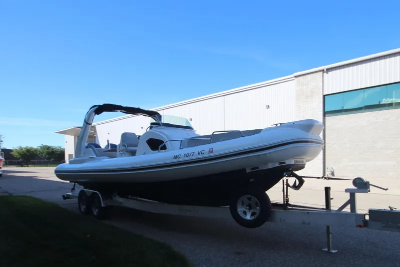 Slide: The Image of 2024 Zodiac MEDLINE 9 NEO boat on trailer, twin 300hp engines, parked outdoors. - 3