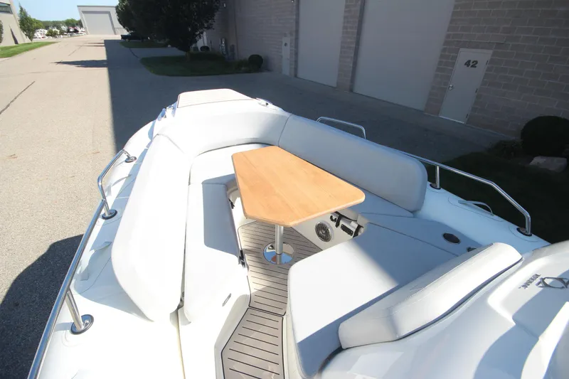 Slide: The Image of 2024 Zodiac MEDLINE 9 NEO boat with seating and wooden table, docked outdoors. - 30