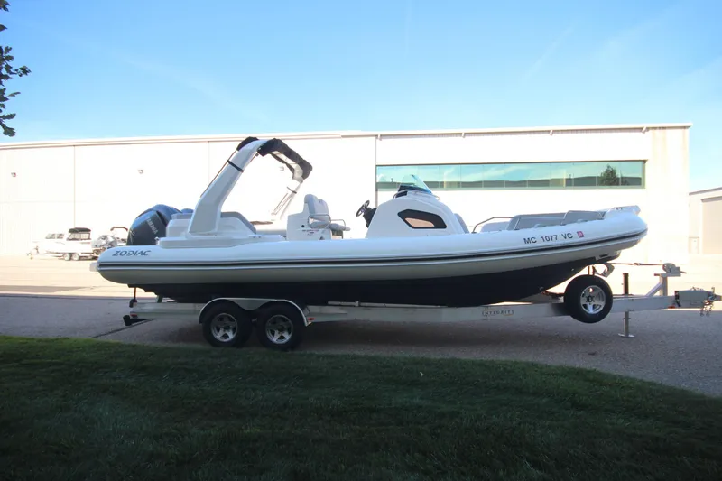 Slide: The Image of 2024 Zodiac MEDLINE 9 NEO boat on trailer, twin 300hp engines, parked outdoors. - 4
