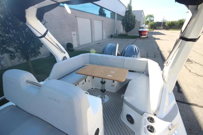 Slide: The Image of 2024 Zodiac MEDLINE 9 NEO boat interior with seating and table, twin 300hp engines visible. - 9