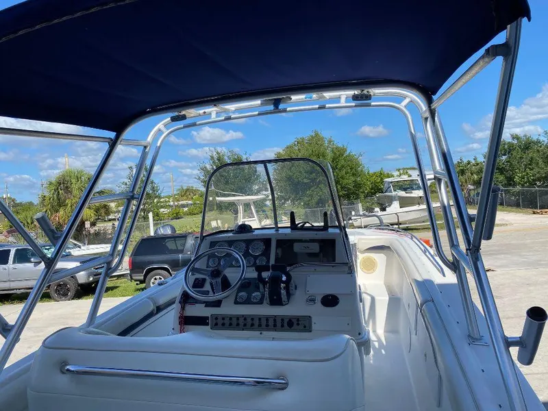 Slide: The Image of 1999 Wellcraft 302 Sport boat cockpit with steering wheel and controls. - 10