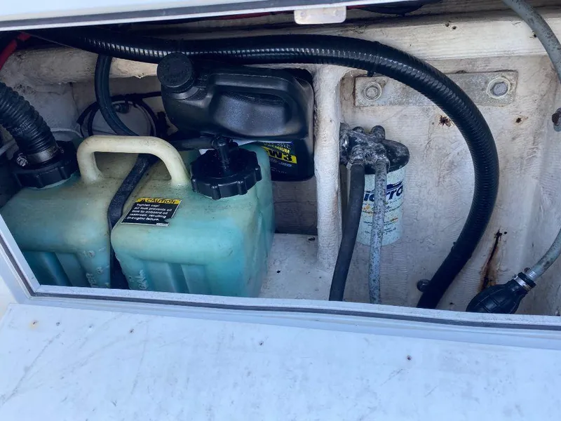 Slide: The Image of Wellcraft 302 Sport 1999 engine compartment with fuel and oil containers. - 11