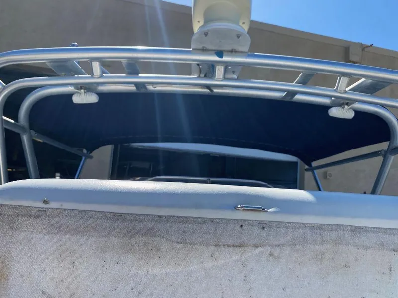 Slide: The Image of 1999 Wellcraft 302 Sport boat with blue canopy and metal frame. - 6