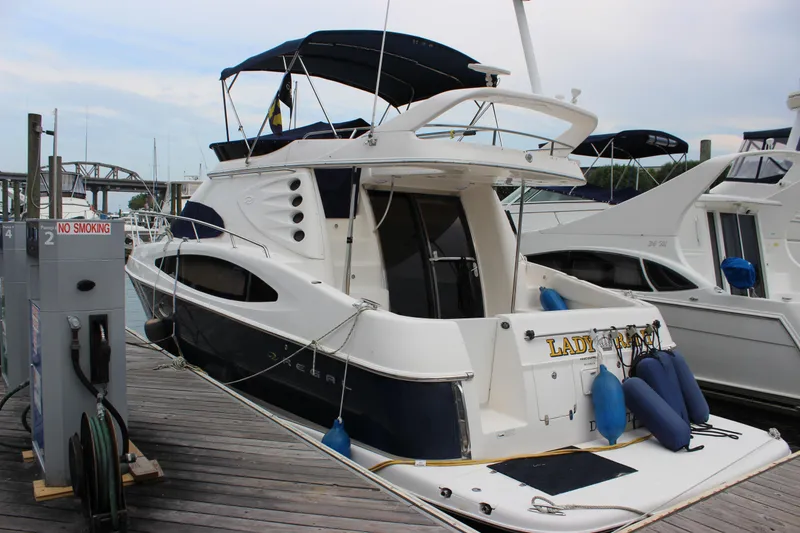 The Image of 2007 Regal 4080 Sportyacht docked, featuring sleek design and spacious deck. - 0
