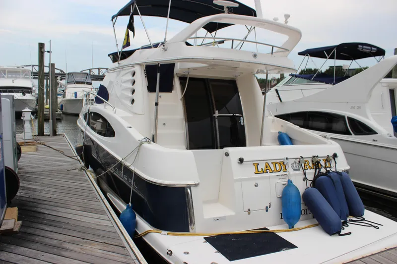 Slide: The Image of 2007 Regal 4080 Sportyacht docked with blue fenders, rear view. - 1