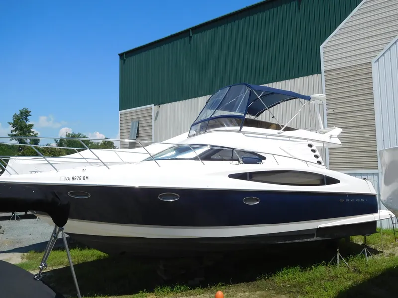 Slide: The Image of 2007 Regal 4080 Sportyacht docked outdoors, featuring sleek design and blue accents. - 11