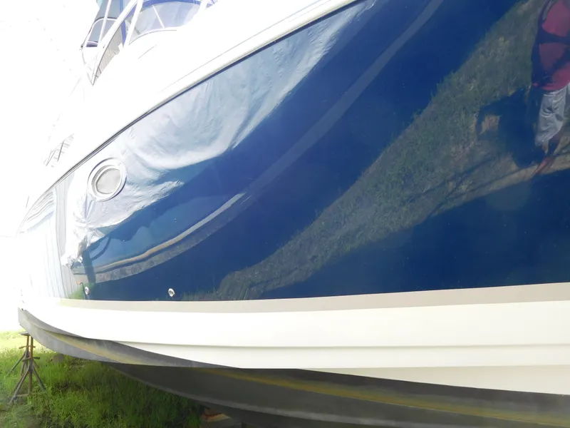 Slide: The Image of 2007 Regal 4080 Sportyacht with sleek blue hull design. - 12