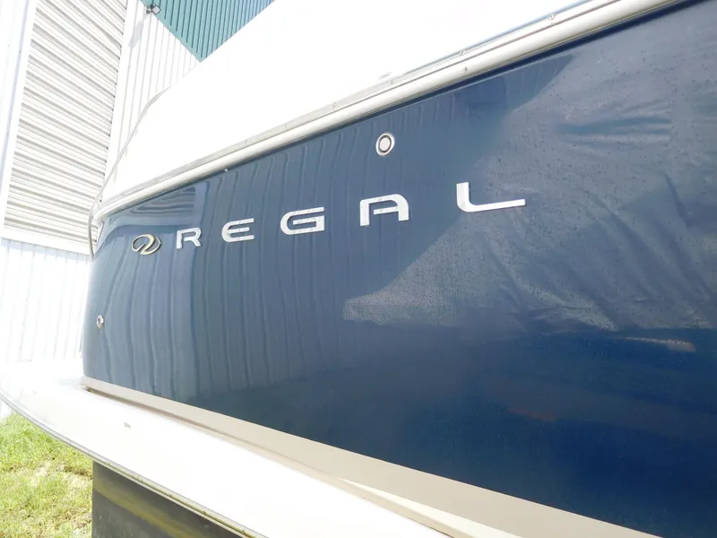 Slide: The Image of 2007 Regal 4080 Sportyacht, blue hull with logo, side view. - 14