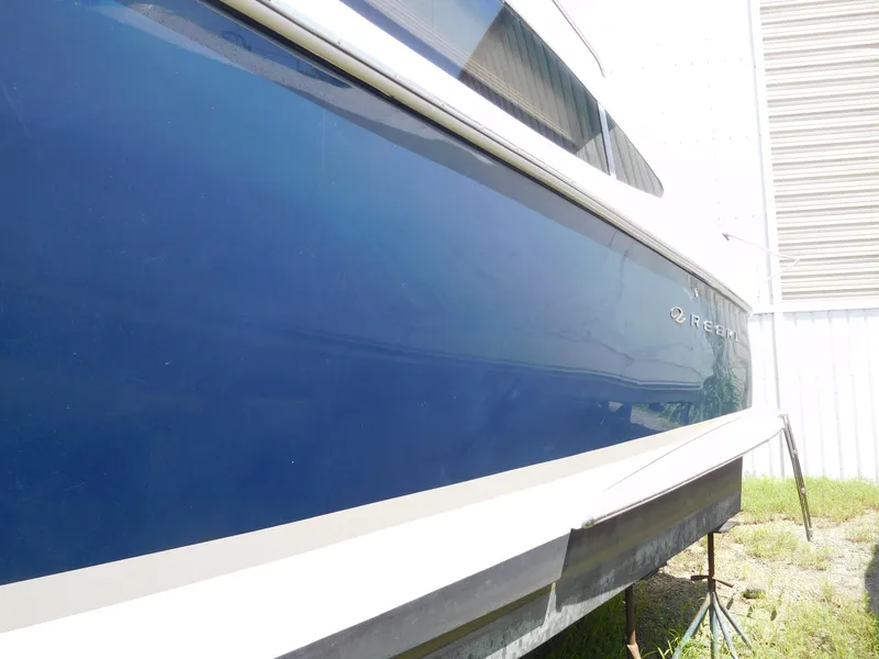 Slide: The Image of 2007 Regal 4080 Sportyacht with sleek blue hull, docked outdoors. - 16
