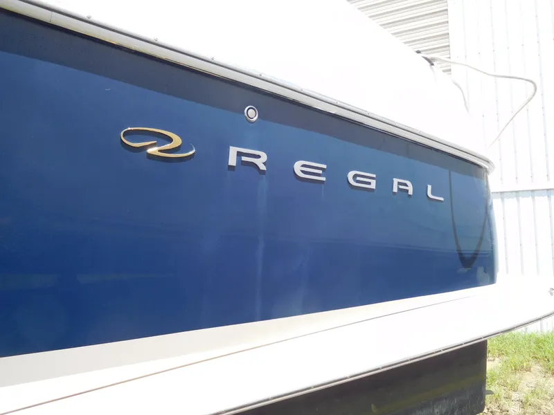 Slide: The Image of 2007 Regal 4080 Sportyacht, blue hull with logo, side view. - 17