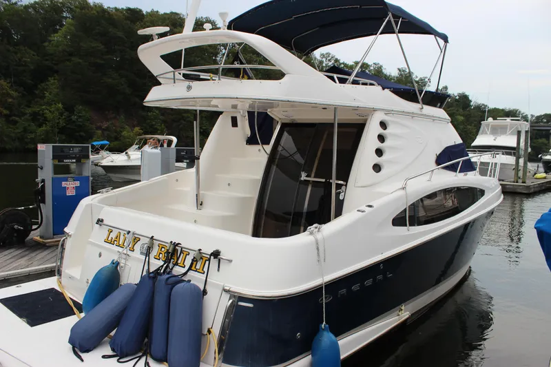 Slide: The Image of 2007 Regal 4080 Sportyacht docked with blue fenders, rear view. - 2
