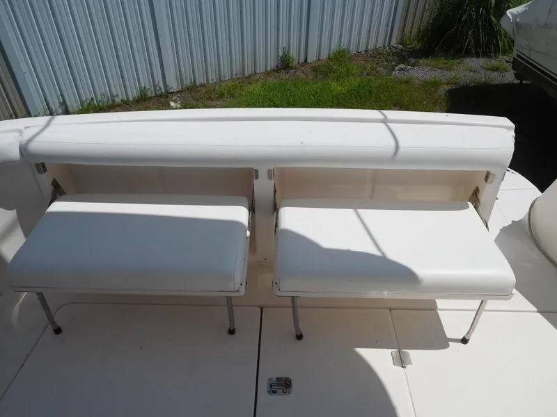 Slide: The Image of White seating on 2007 Regal 4080 Sportyacht deck, near metal fence. - 23