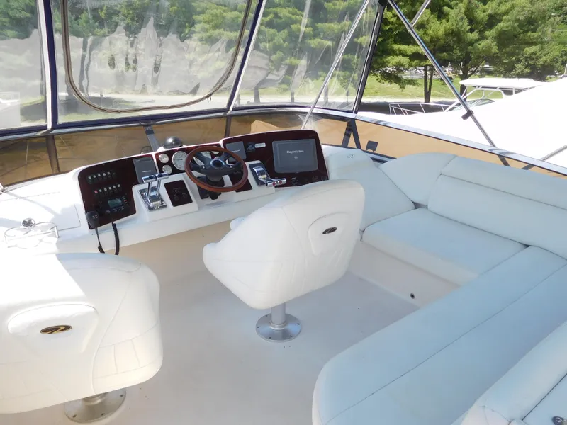 Slide: The Image of Luxurious 2007 Regal 4080 Sportyacht cockpit with white seating and modern controls. - 26