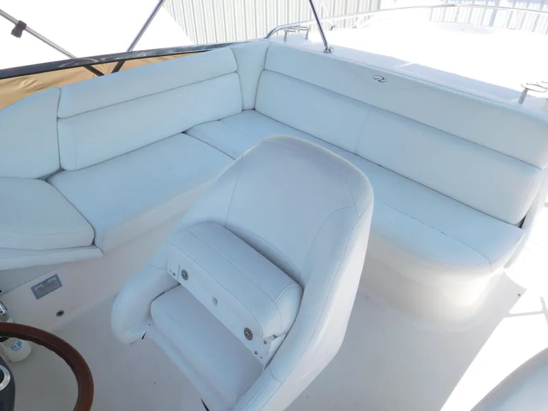 Slide: The Image of 2007 Regal 4080 Sportyacht interior with white seating and helm chair. - 27