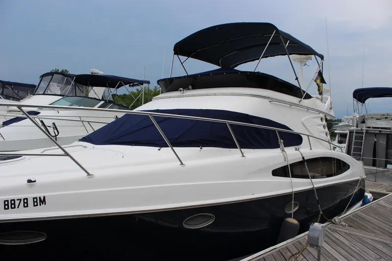 Slide: The Image of 2007 Regal 4080 Sportyacht docked at marina, featuring sleek design and covered upper deck. - 3