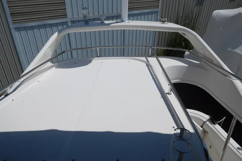 Slide: The Image of 2007 Regal 4080 Sportyacht deck with railing, docked near metal siding. - 31