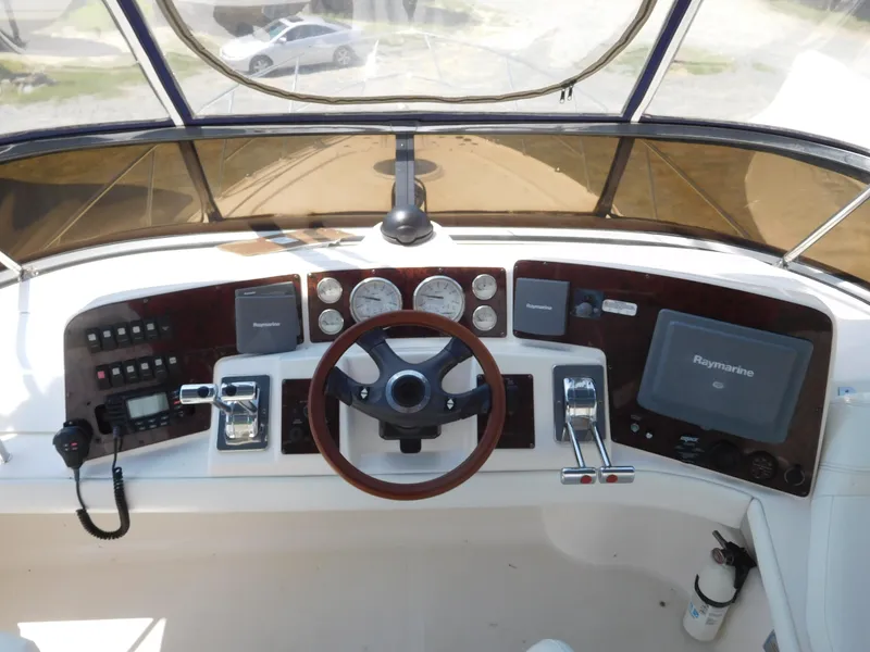 Slide: The Image of Dashboard of 2007 Regal 4080 Sportyacht with steering wheel and navigation controls. - 32