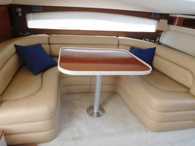 Slide: The Image of Luxurious interior of 2007 Regal 4080 Sportyacht with beige seating and wooden table. - 37