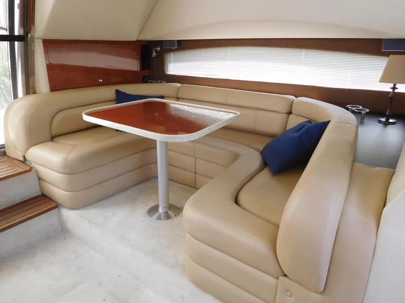 Slide: The Image of Luxurious interior of 2007 Regal 4080 Sportyacht with beige leather seating and wooden table. - 39