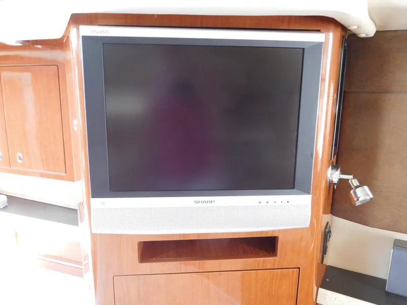 Slide: The Image of Sharp TV in 2007 Regal 4080 Sportyacht interior with wooden cabinetry. - 42